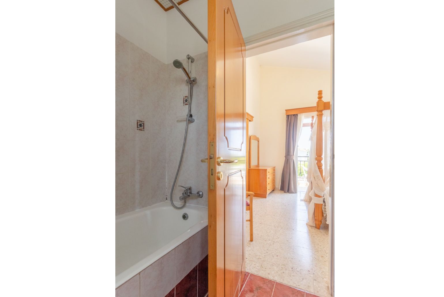 En suite bathroom with bath and overhead shower