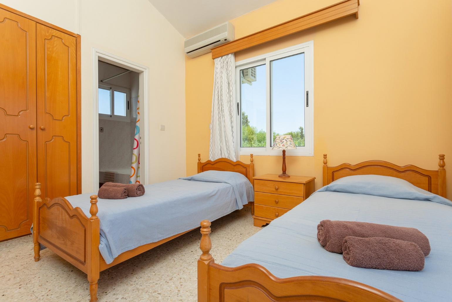 Twin bedroom with en suite bathroom, A/C, and balcony access with sea views