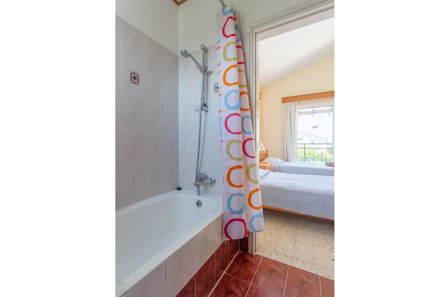 En suite bathroom with bath and overhead shower