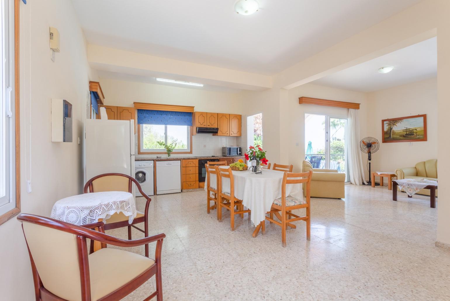 Open-plan living room with dining area, kitchen, WiFi Internet, TV and DVD player, and terrace access