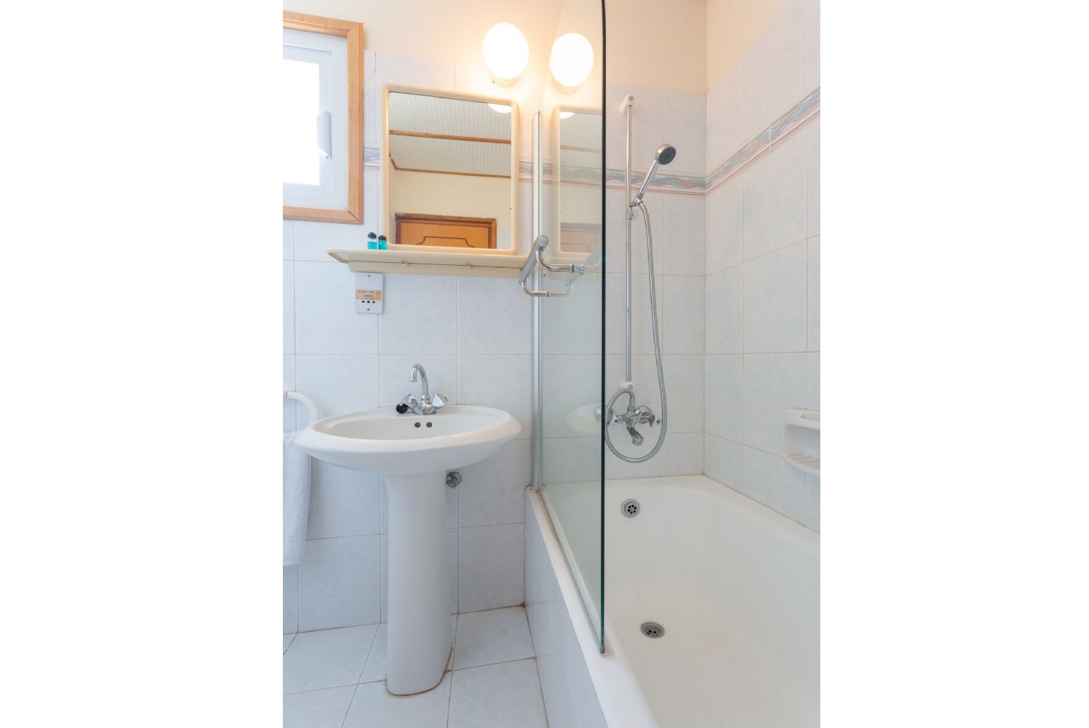 En suite bathroom with bath and overhead shower