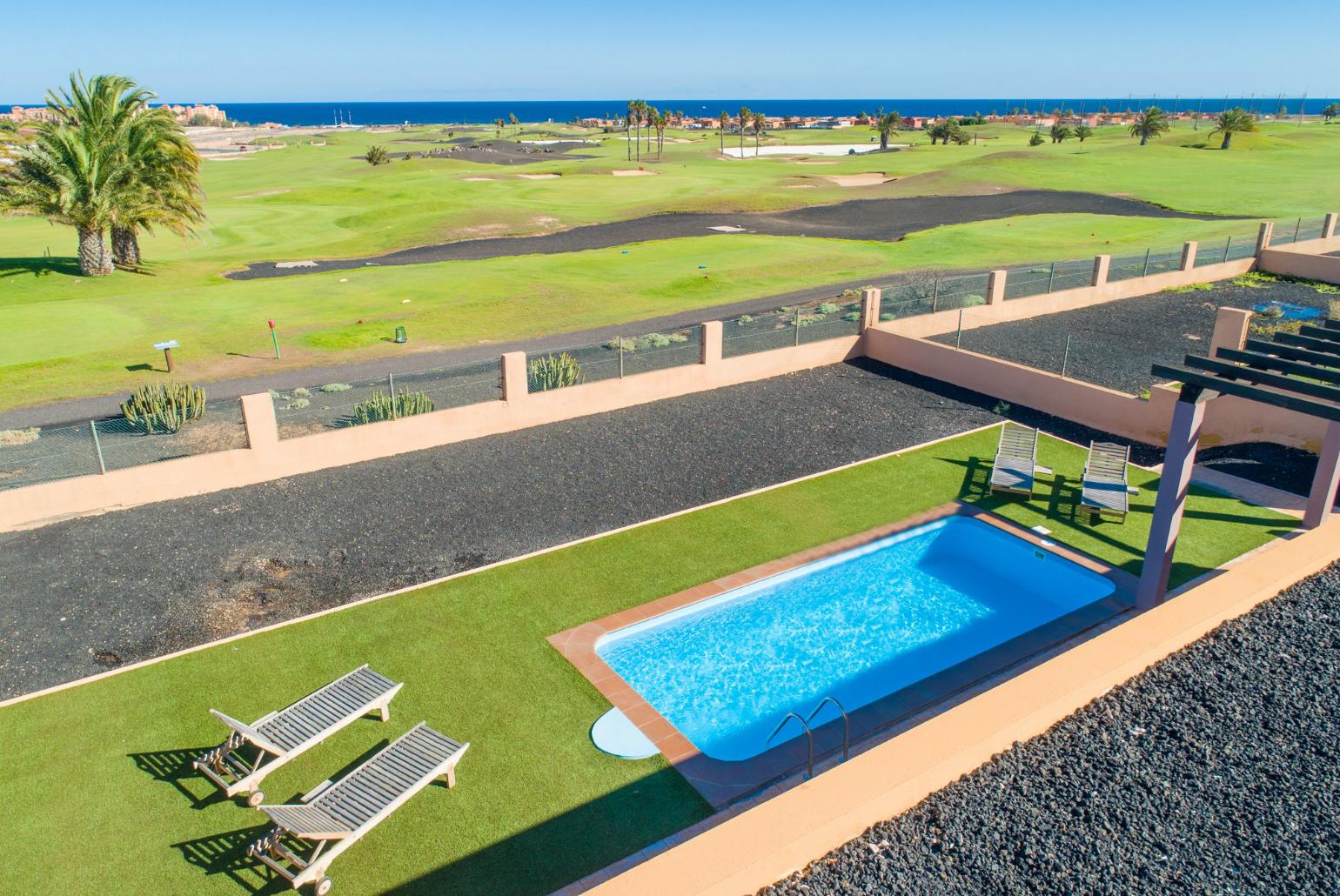Aerial view of pool terrace with sea views