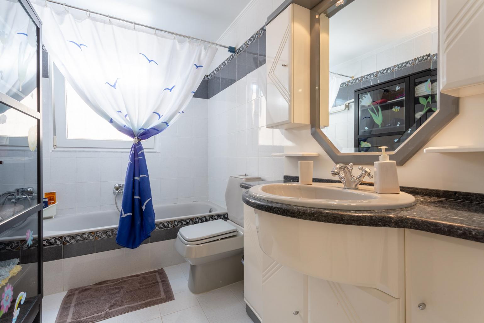 Family bathroom with bath and shower