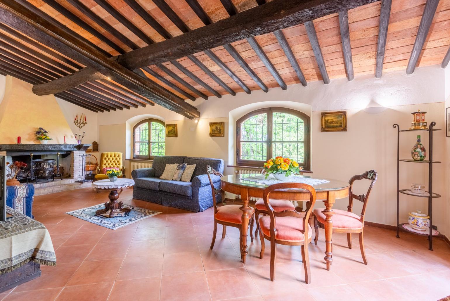 Living room with sofas, dining area, ornamental fireplace, WiFi internet, satellite TV, and garden access