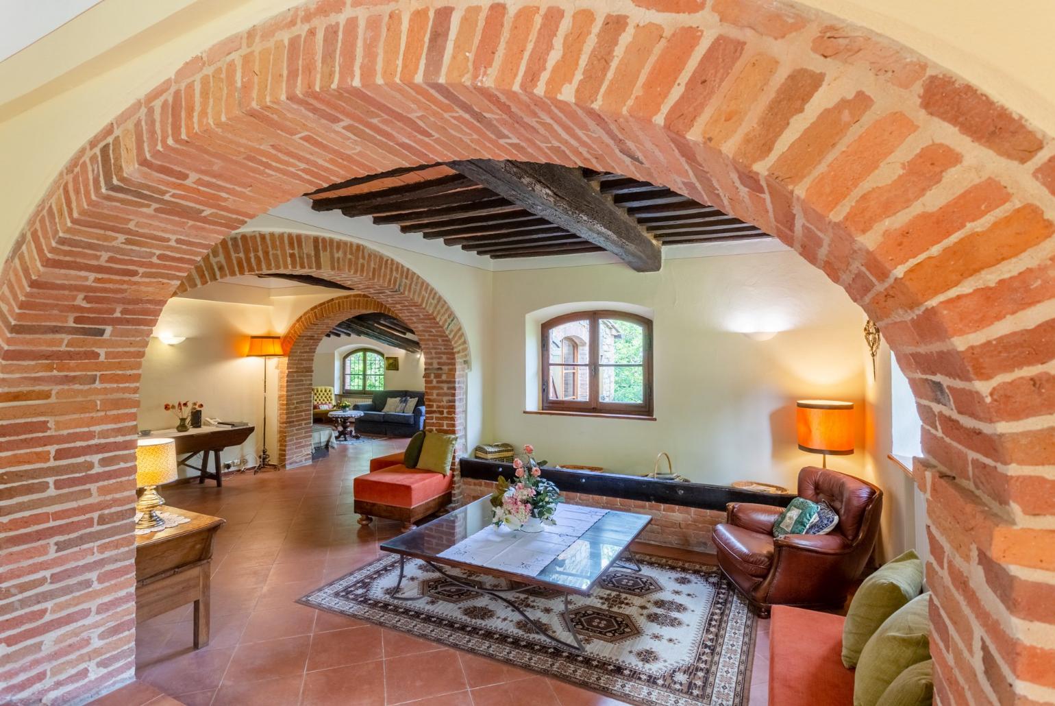 Living room with sofas, dining area, ornamental fireplace, WiFi internet, satellite TV, and garden access