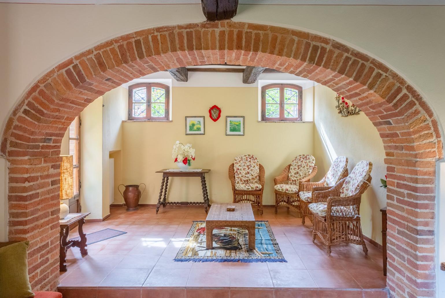 Living room with sofas, dining area, ornamental fireplace, WiFi internet, satellite TV, and garden access