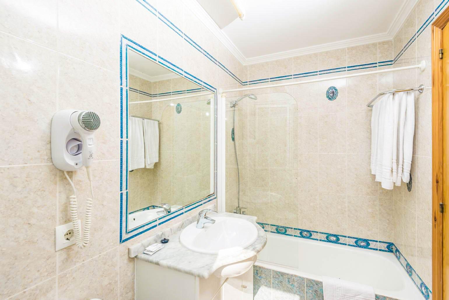 En suite bathroom with bath and shower. W/C.