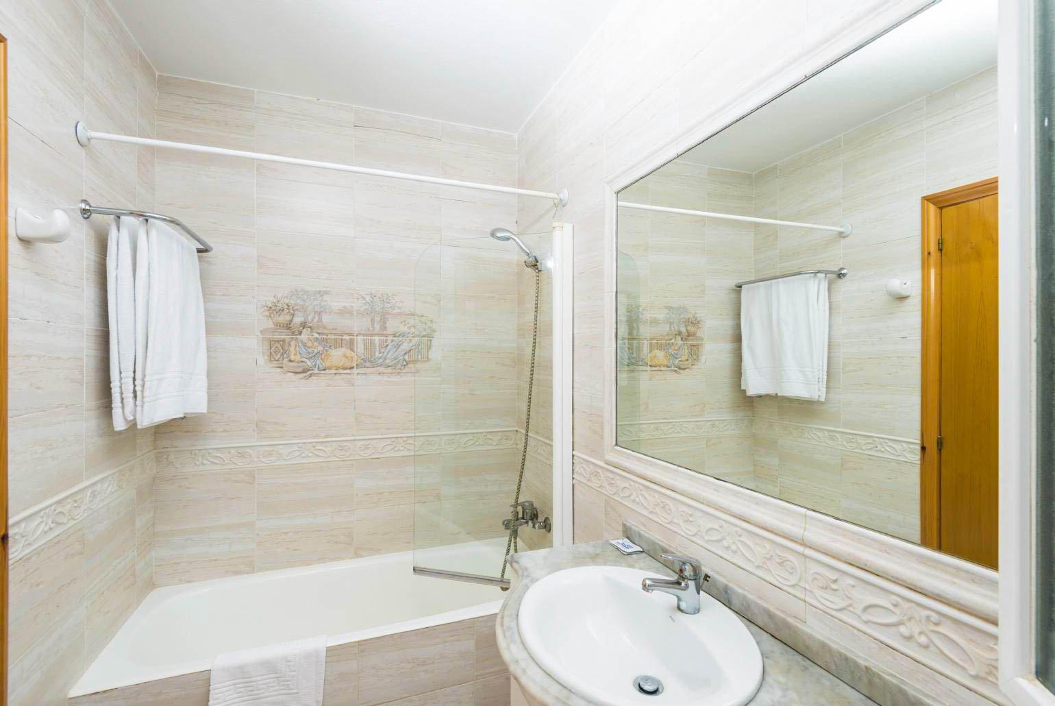En suite bathroom with shower and bath. W/C.