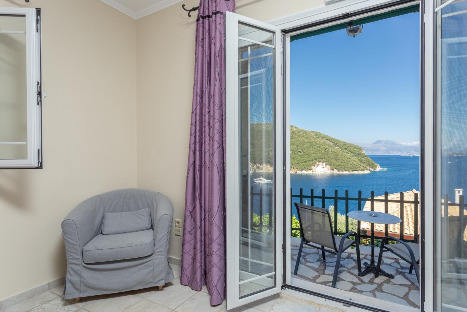 Double bedroom with extra single bed, en suite bathroom, AC, and terrace access with panoramic sea views