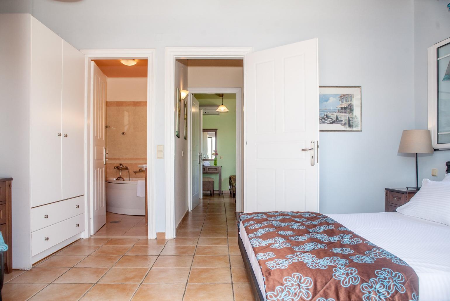 Double bedroom with en suite bathroom, A/C, and balcony access with sea views