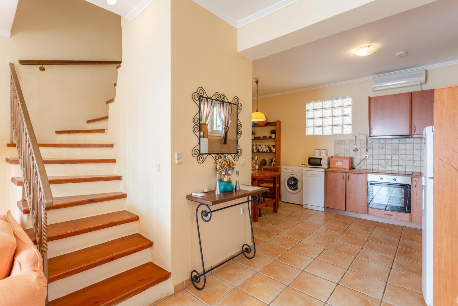 Open-plan living room with sofas, dining area, kitchen, ornamental fireplace, A/C, WiFi internet, satellite TV, and terrace access with panoramic sea views