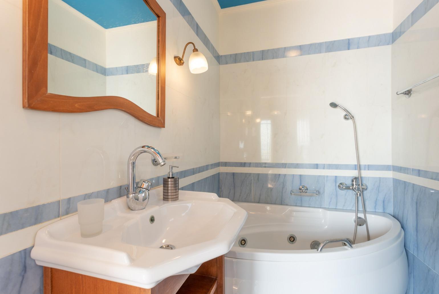 En suite bathroom with spa bath and shower 