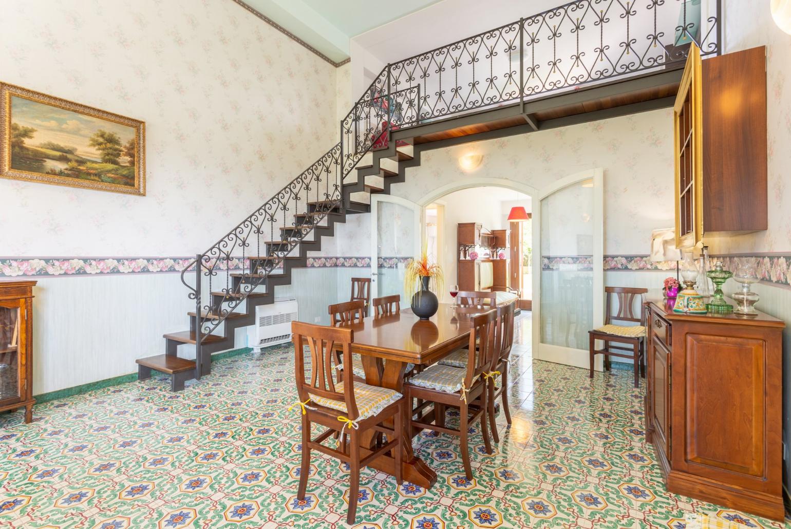 Living room with mezzanine, sofas, dining area, A/C, WiFi internet, satellite TV, and terrace access