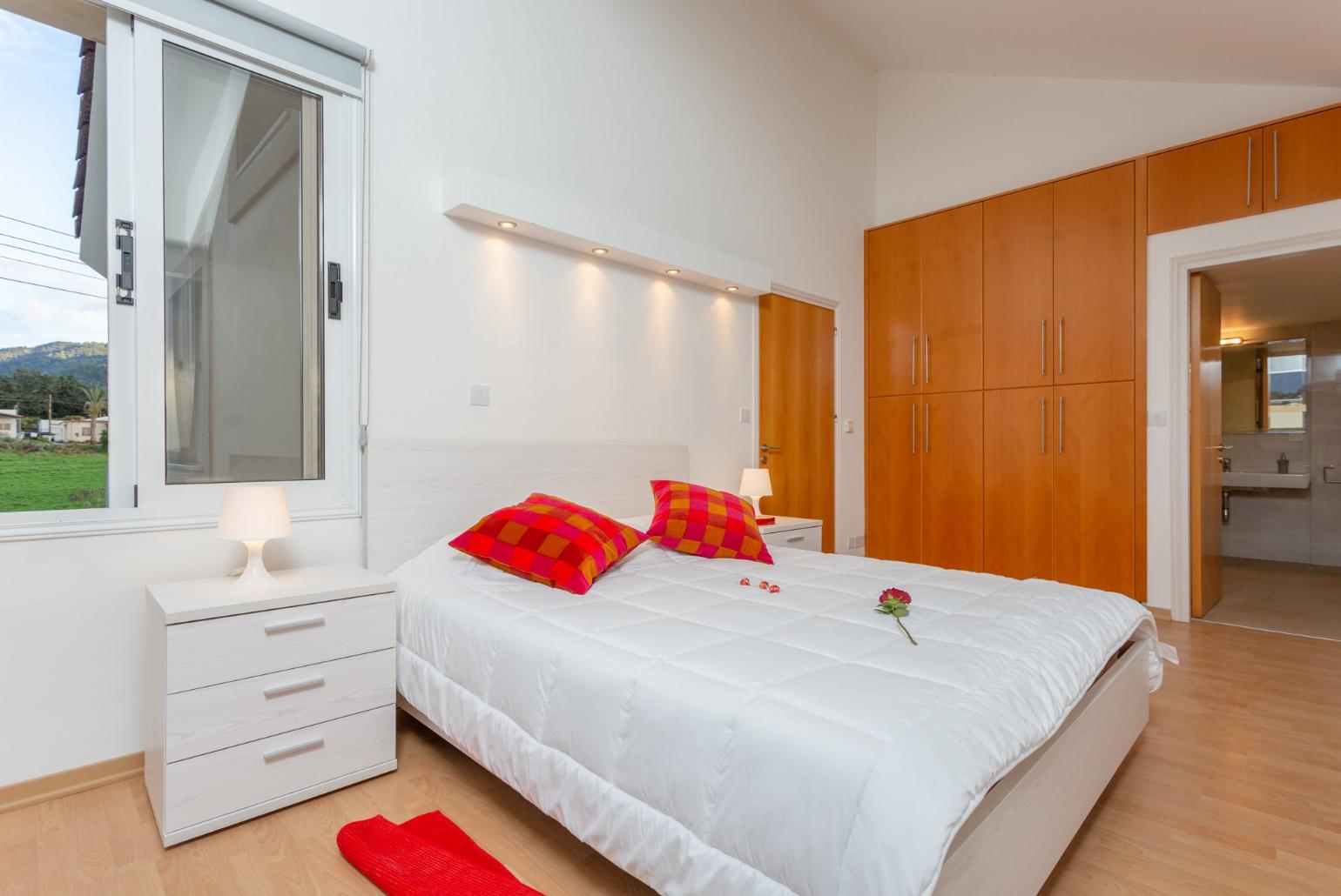 Double bedroom with en suite bathroom, A/C, panoramic sea views, and balcony access