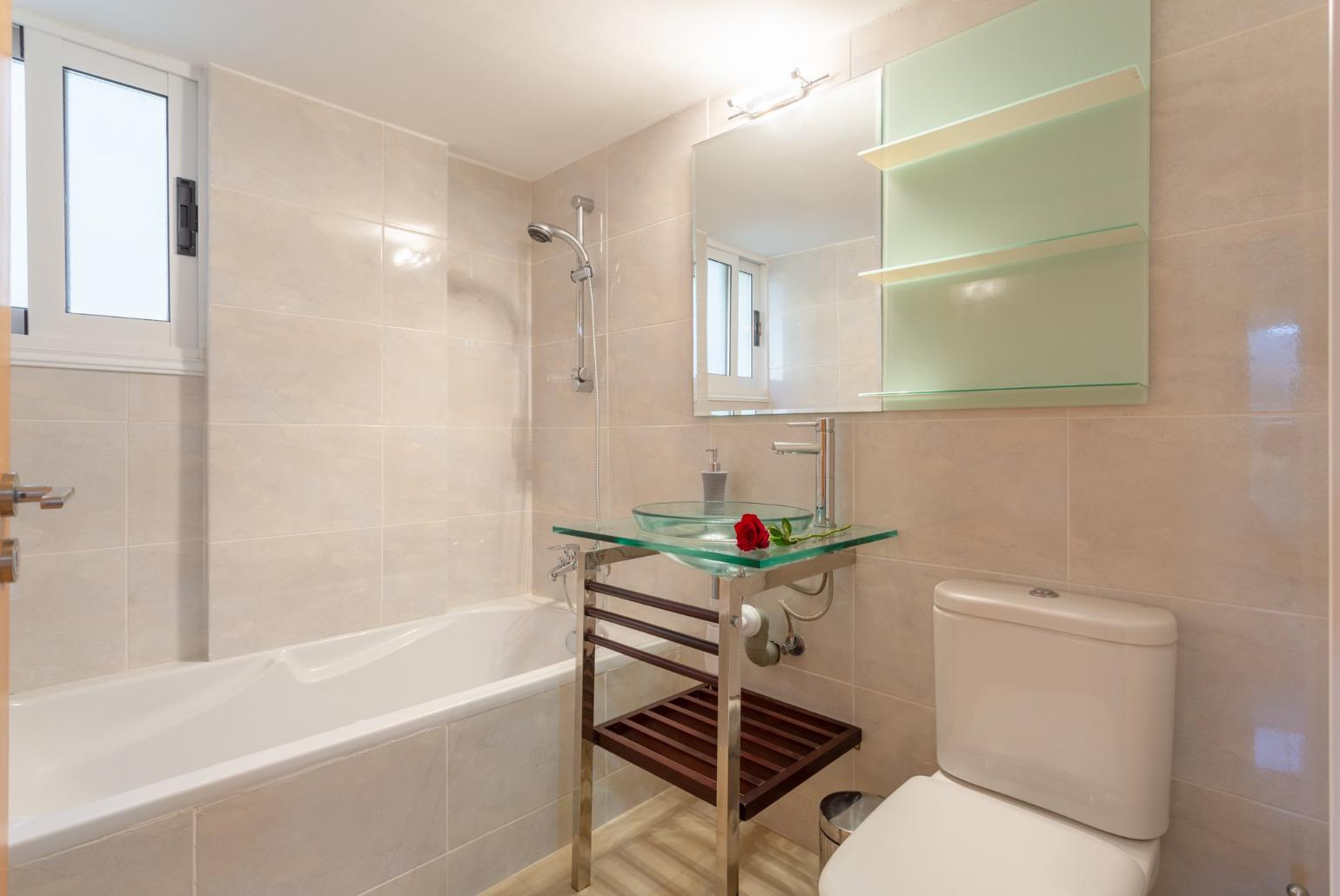 En suite bathroom with bath and shower