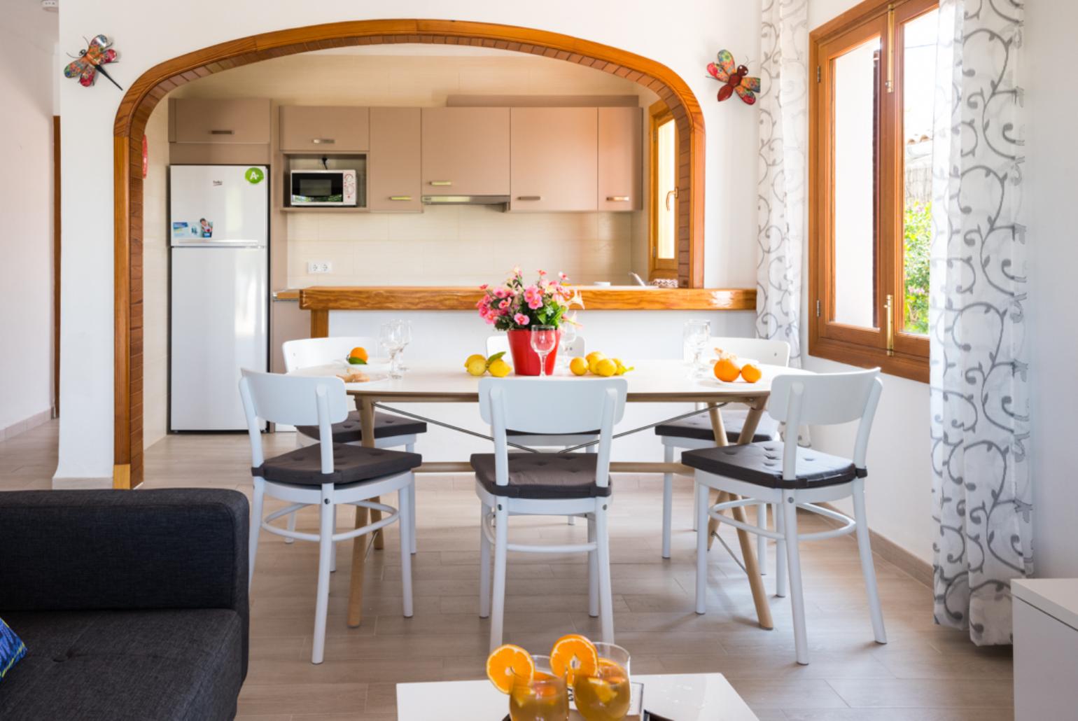 Open-plan living room with sofas, dining area, kitchen,  WiFi internet, and satellite TV