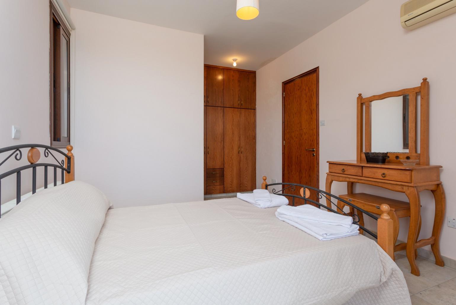 Double bedroom with en suite bathroom, A/C, and balcony access with views of sea and countryside