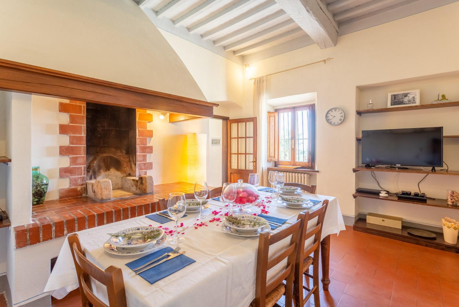 Dining room with kitchen, ornamental fireplace, WiFi internet, satellite TV, and terrace access