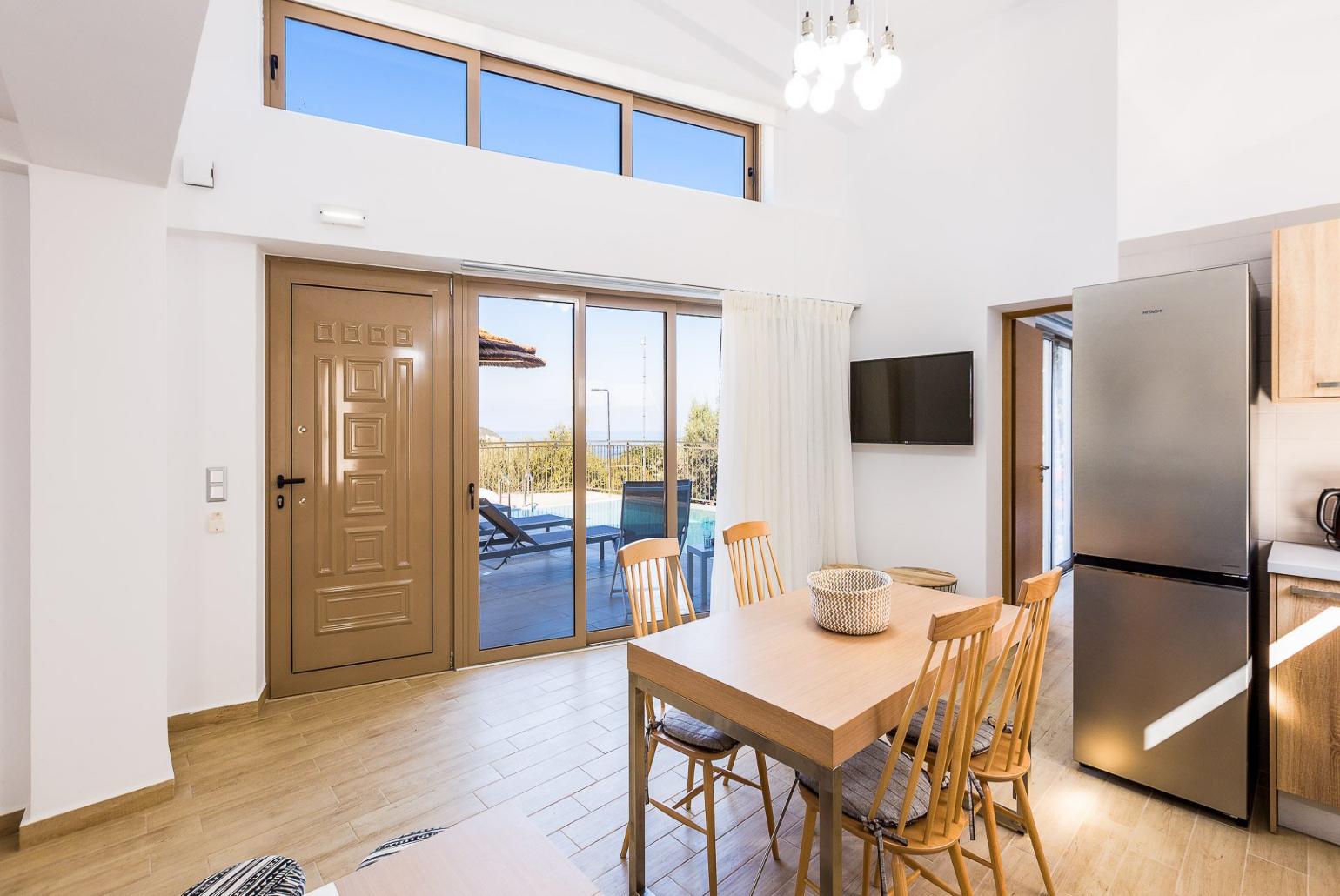 Open-plan living room with sofa, dining area, kitchen