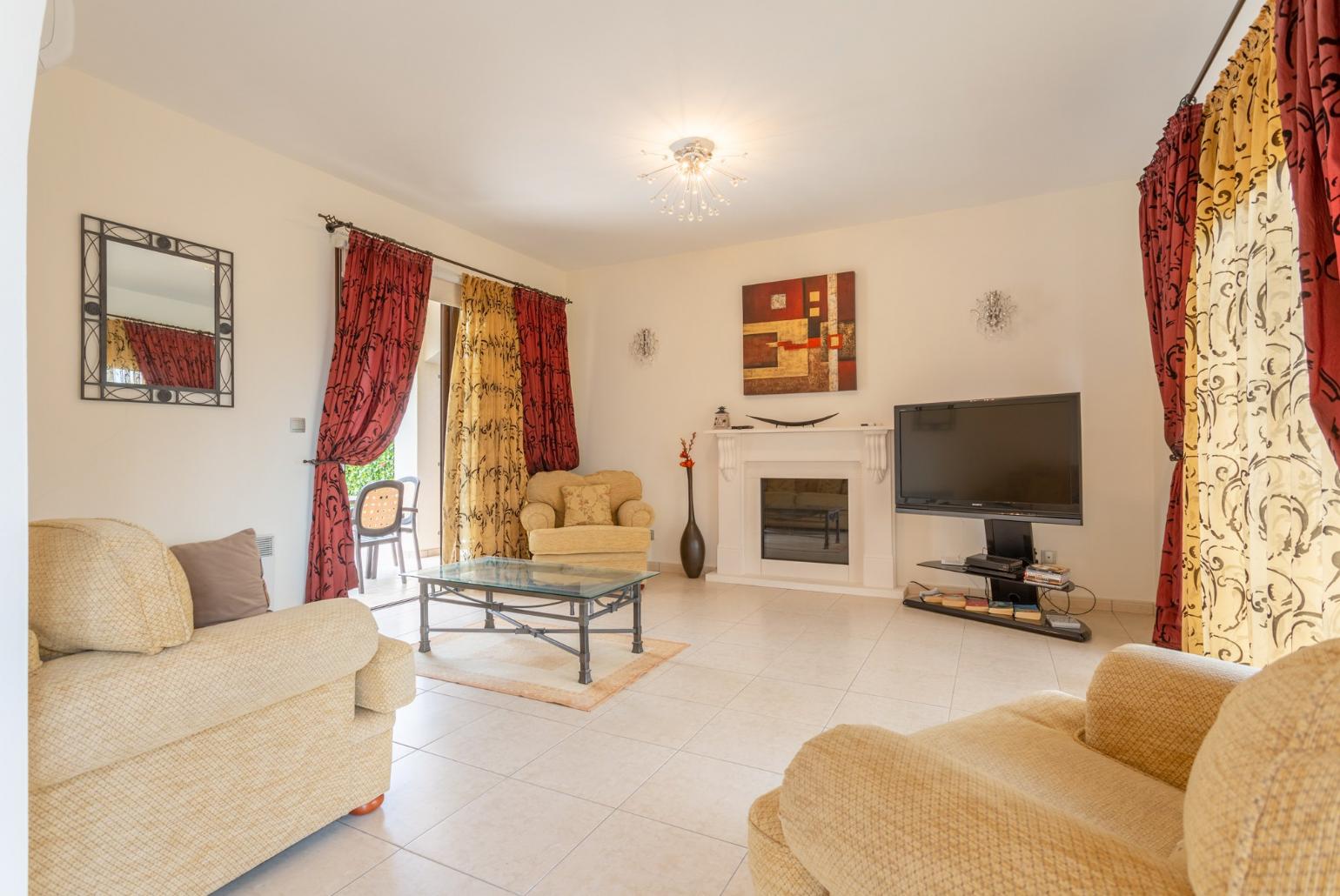 Living room with sofas, ornamental fireplace, A/C, WiFi internet, satellite TV, DVD player, and pool terrace and balcony access