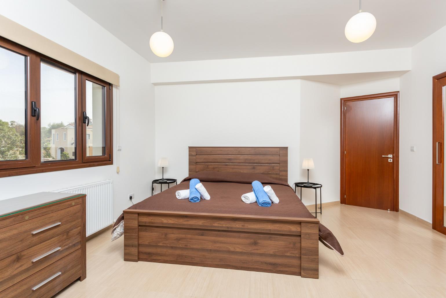 Double bedroom with en suite bathroom, A/C, and balcony access