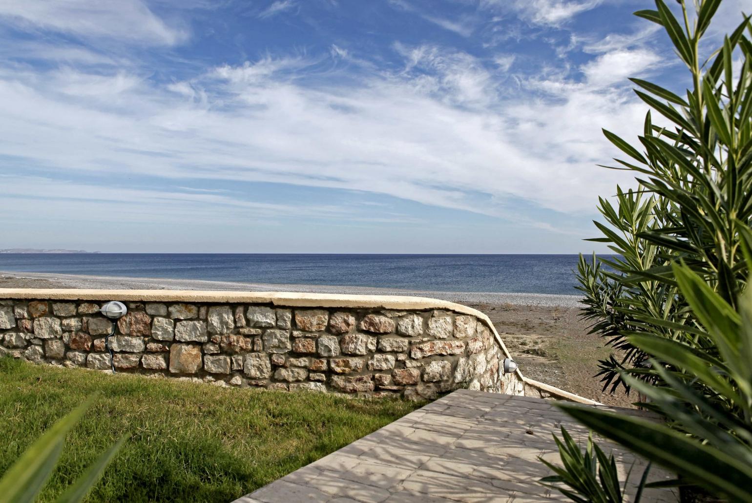 Lawn with panoramic sea views and beach access