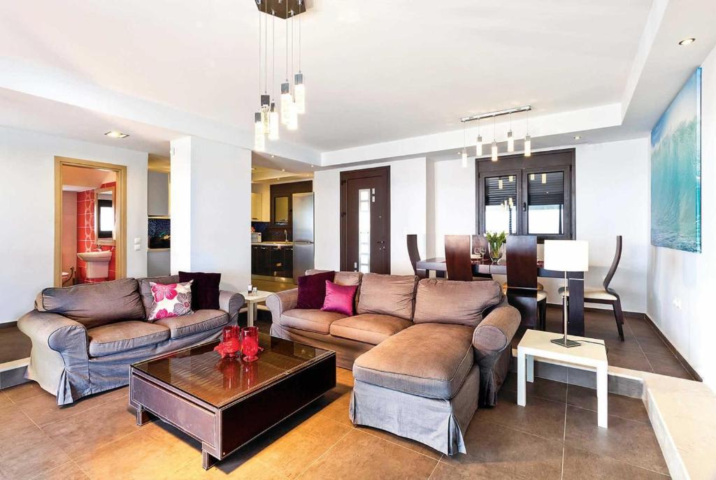Open-plan living room with Air-Conditioning Ornamental fireplace Free WIFI  Satellite TV  Lounge TV  DVD Player  Comfortable Sofas  Dining Area  Lounge Sea Views