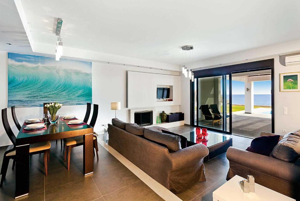 Open-plan living room with Air-Conditioning Ornamental fireplace Free WIFI  Satellite TV  Lounge TV  DVD Player  Comfortable Sofas  Dining Area  Lounge Sea Views