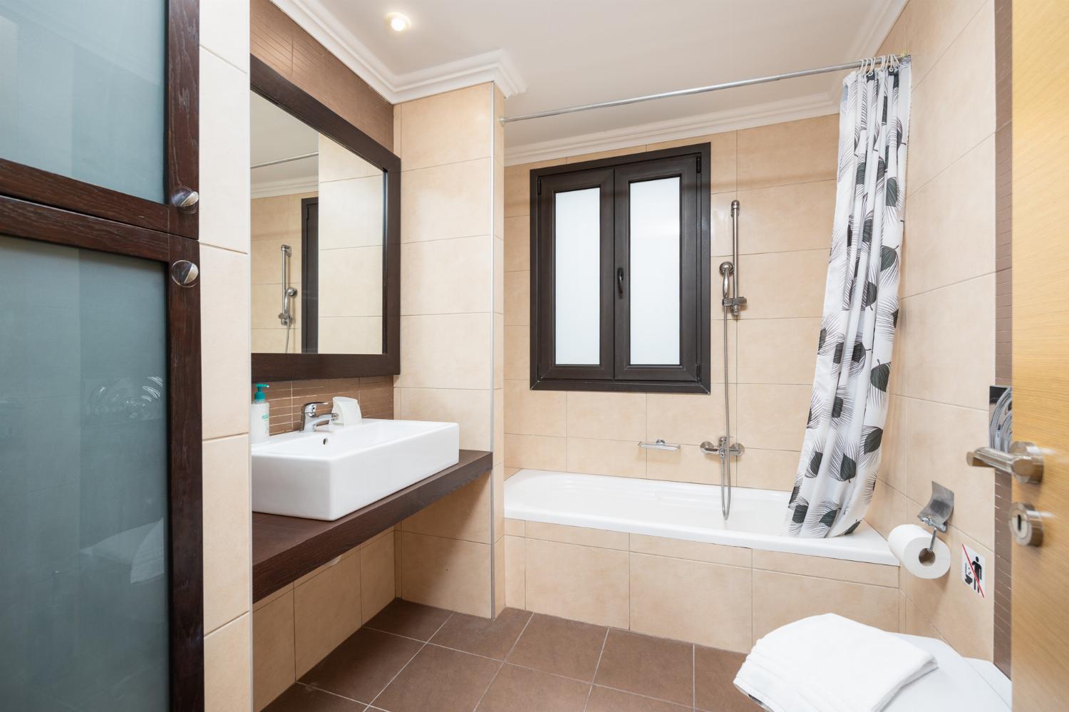 Family bathroom with bath and shower