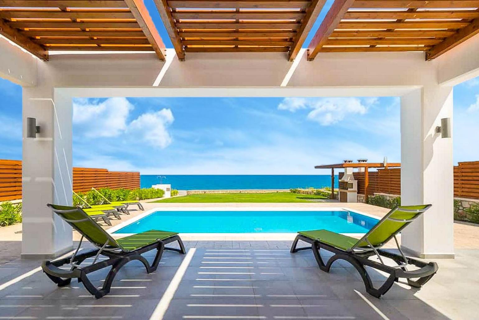Beautiful villa with private pool, terrace, and lawn with panoramic sea views