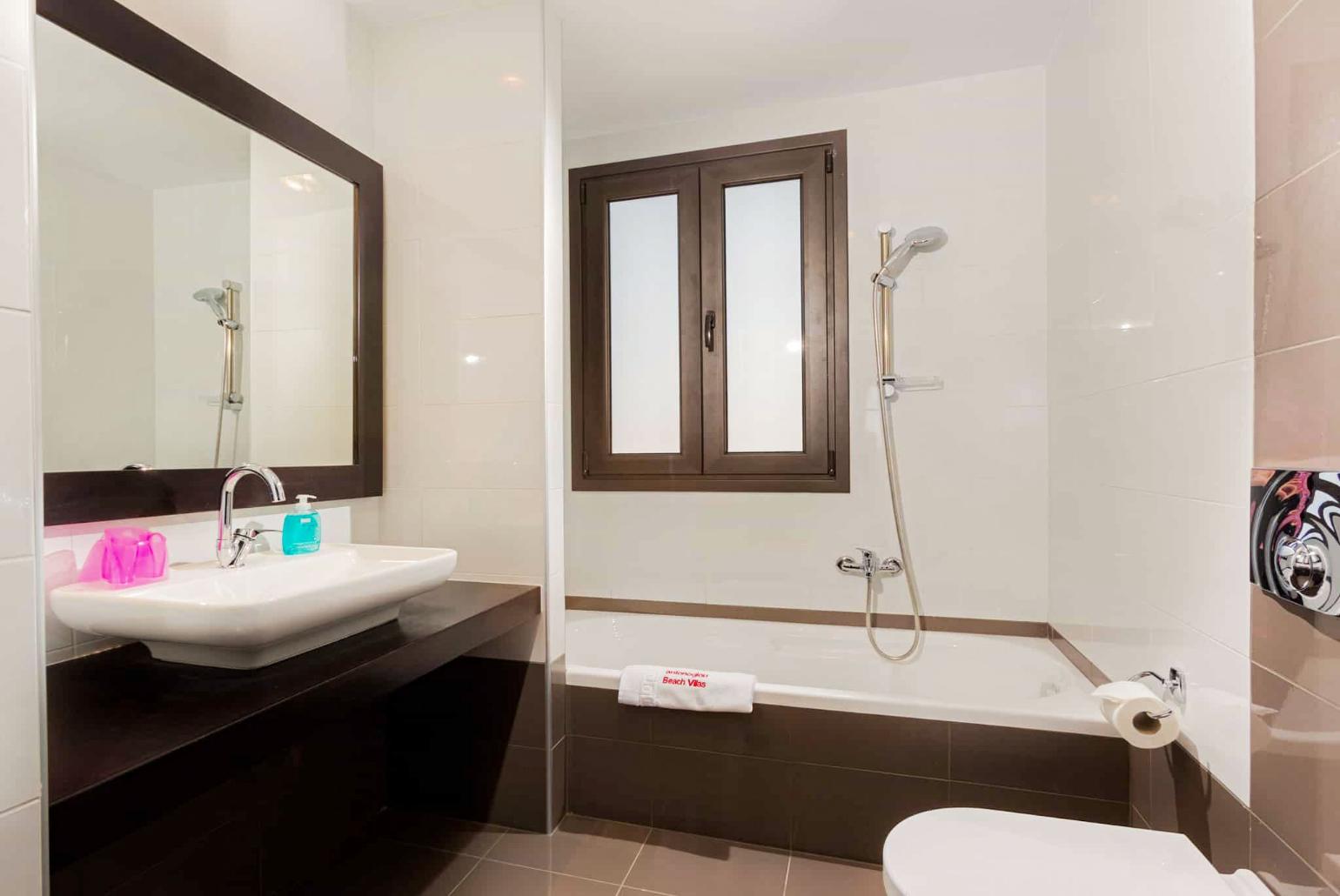 Family bathroom, bath with shower. W/C.