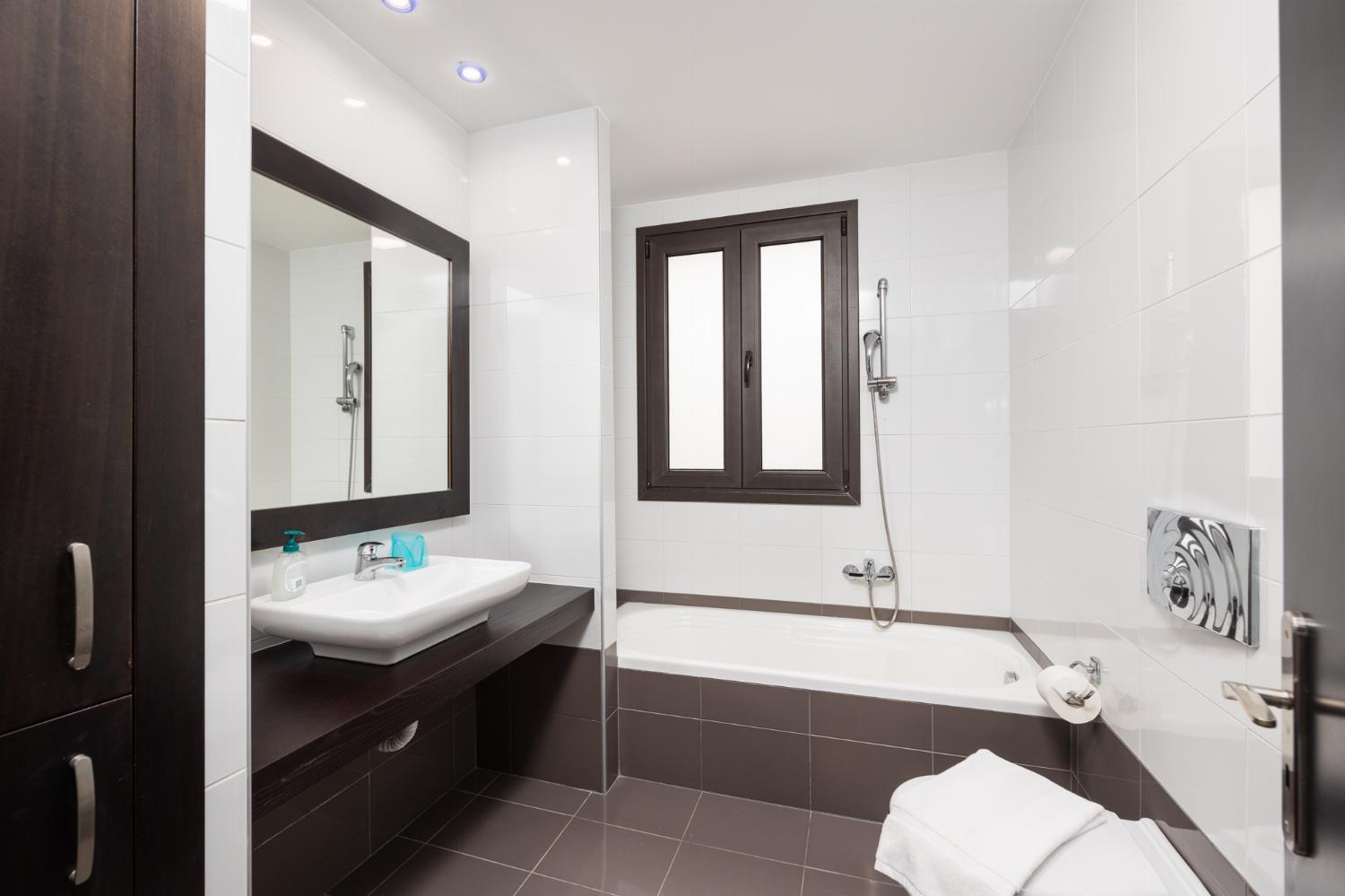 Family bathroom with bath and shower