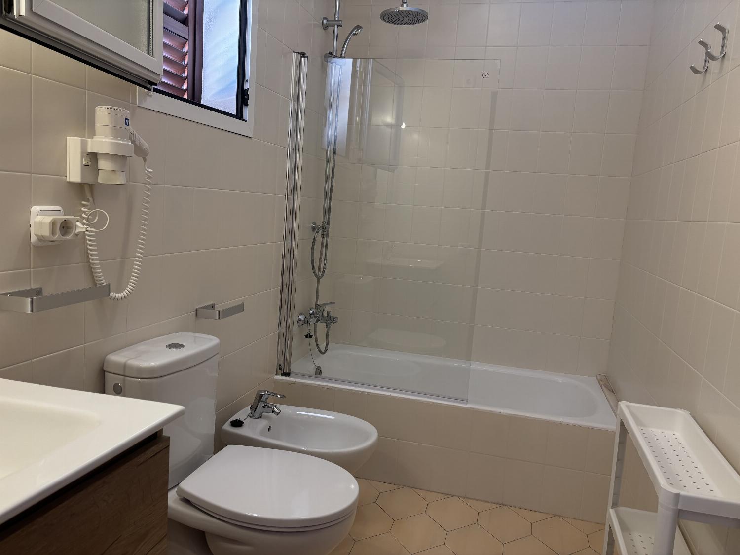 En suite bathroom with shower and bath. W/C.