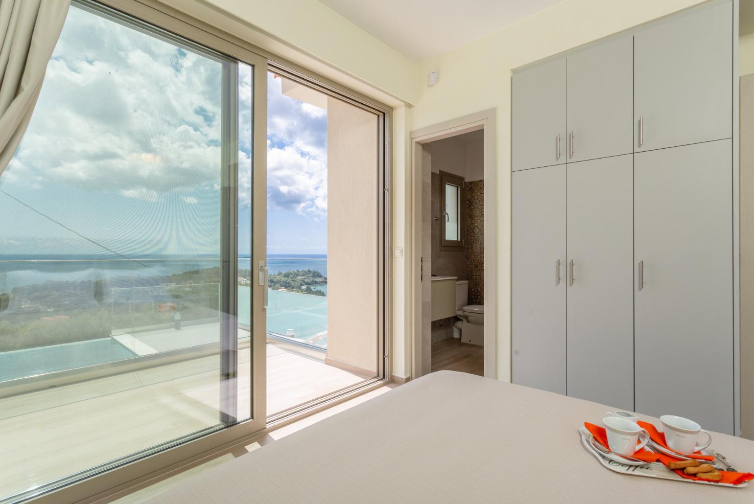 Double bedroom with en suite bathroom, A/C, and terrace access with sea views