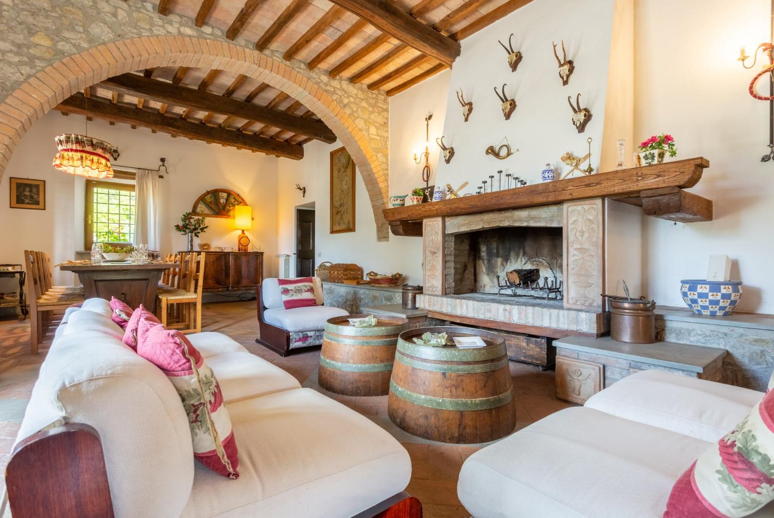 Living room on ground floor with sofas, dining area, ornamental fireplace, WiFi internet, satellite TV, and terrace access