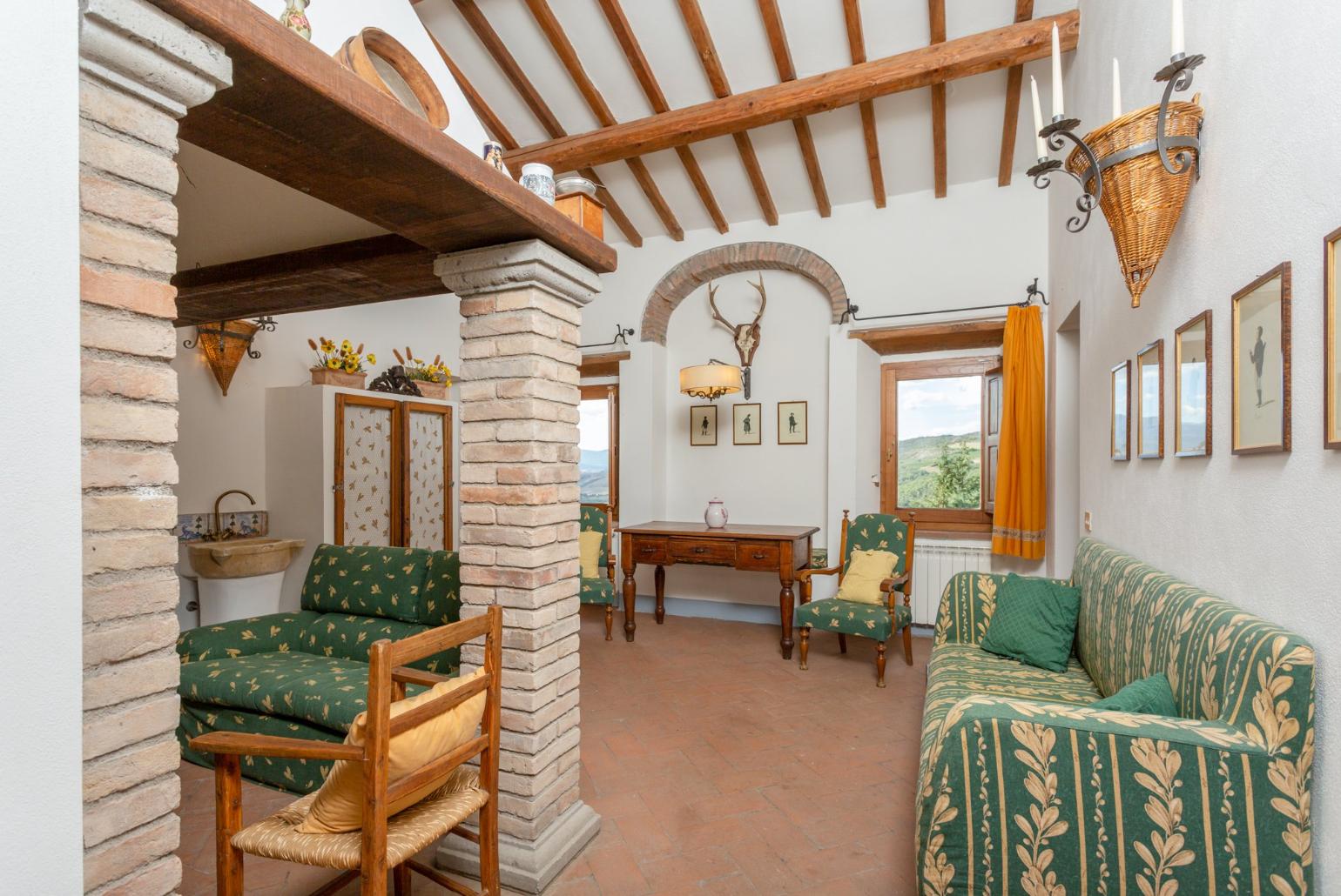 Living room on first floor with sofas and ornamental fireplace