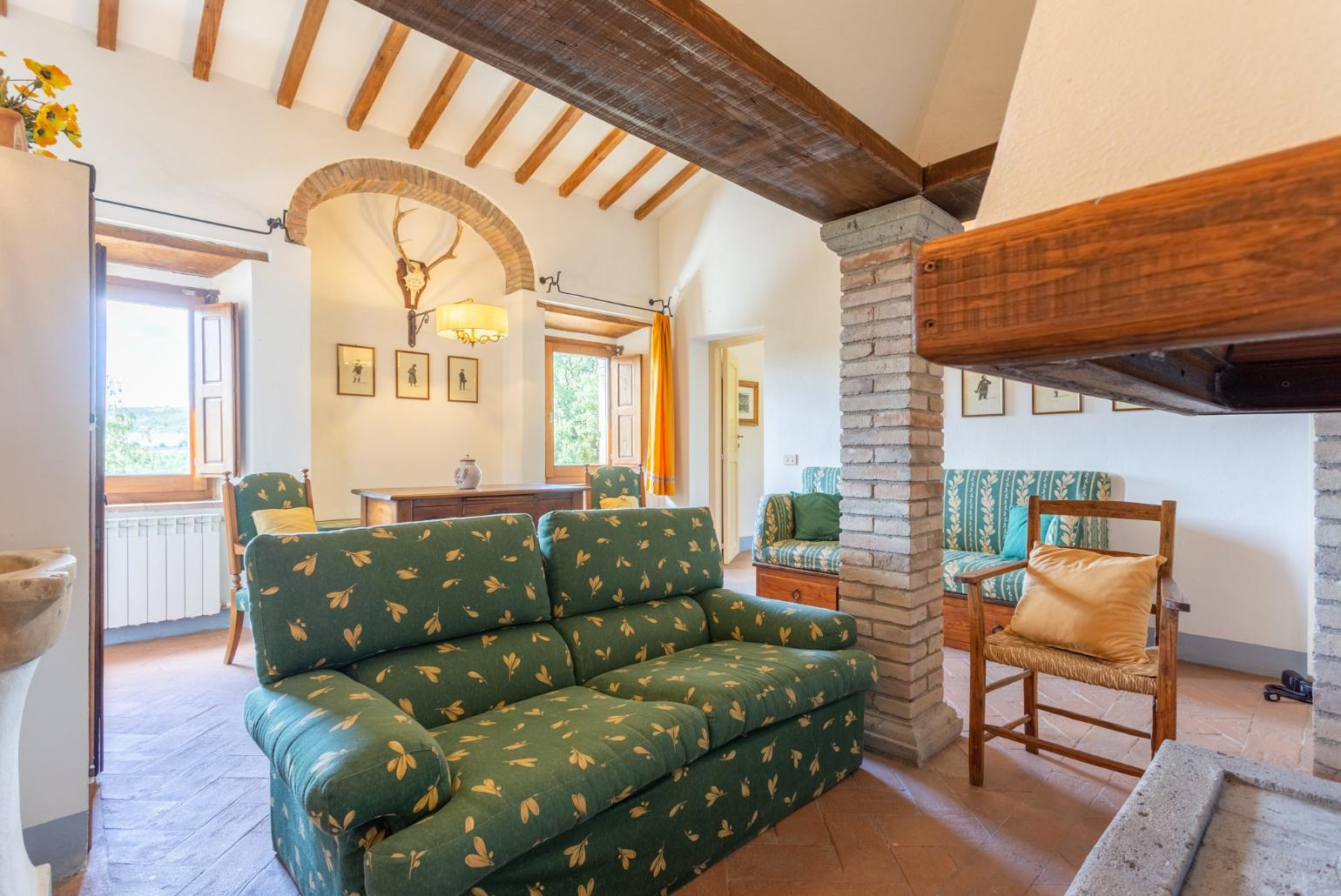 Living room on first floor with sofas and ornamental fireplace