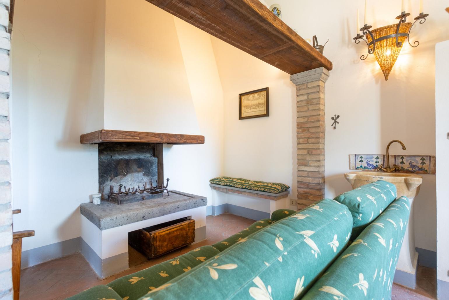 Living room on first floor with sofas and ornamental fireplace