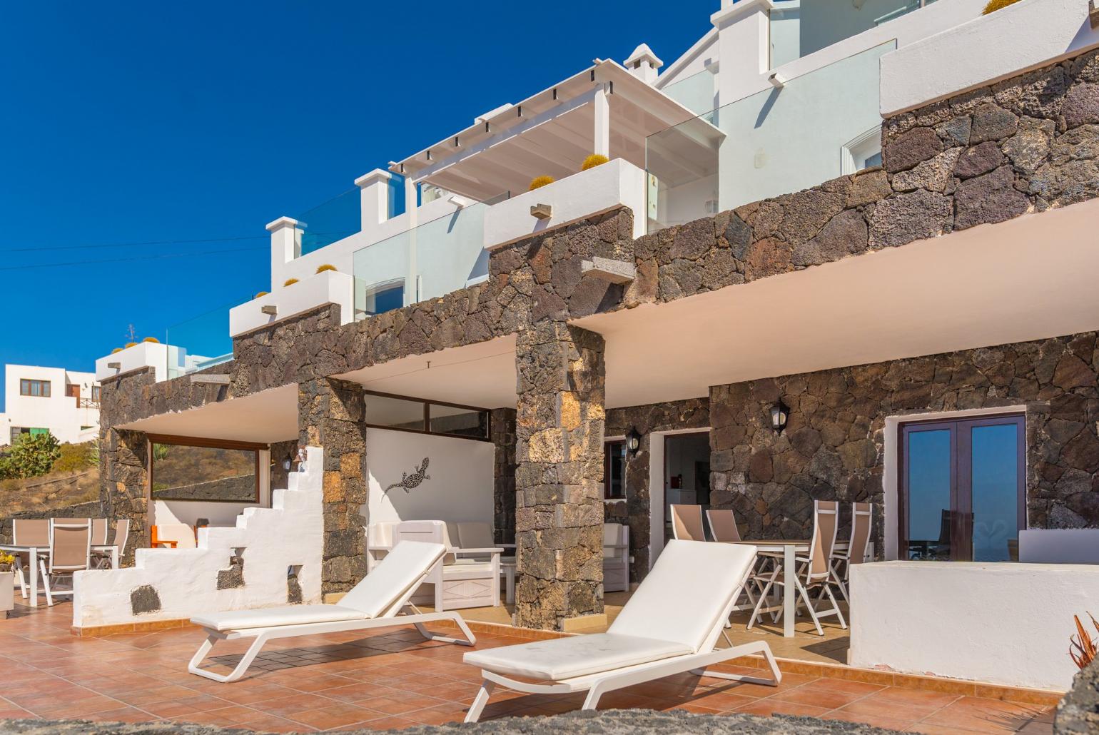 Pool area with sunbeds,sheltered dining area and outdoor BBQ