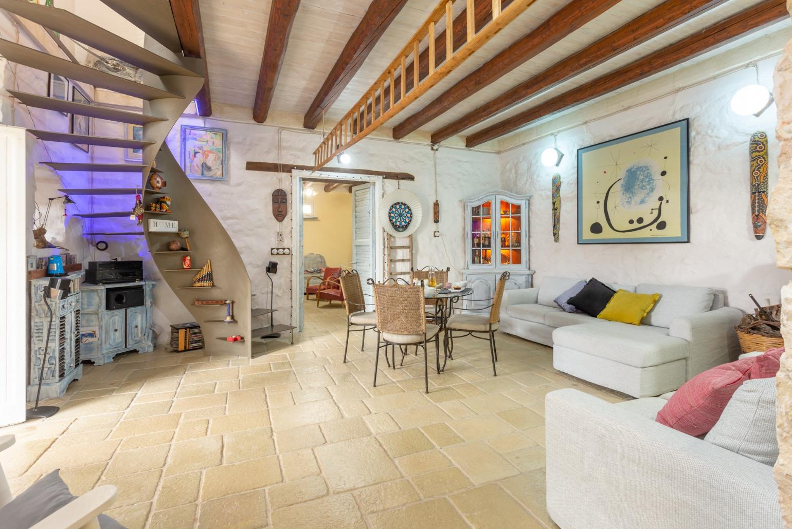 Living room with sofas, dining area, ornamental fireplace, WiFi internet, satellite TV, and terrace access