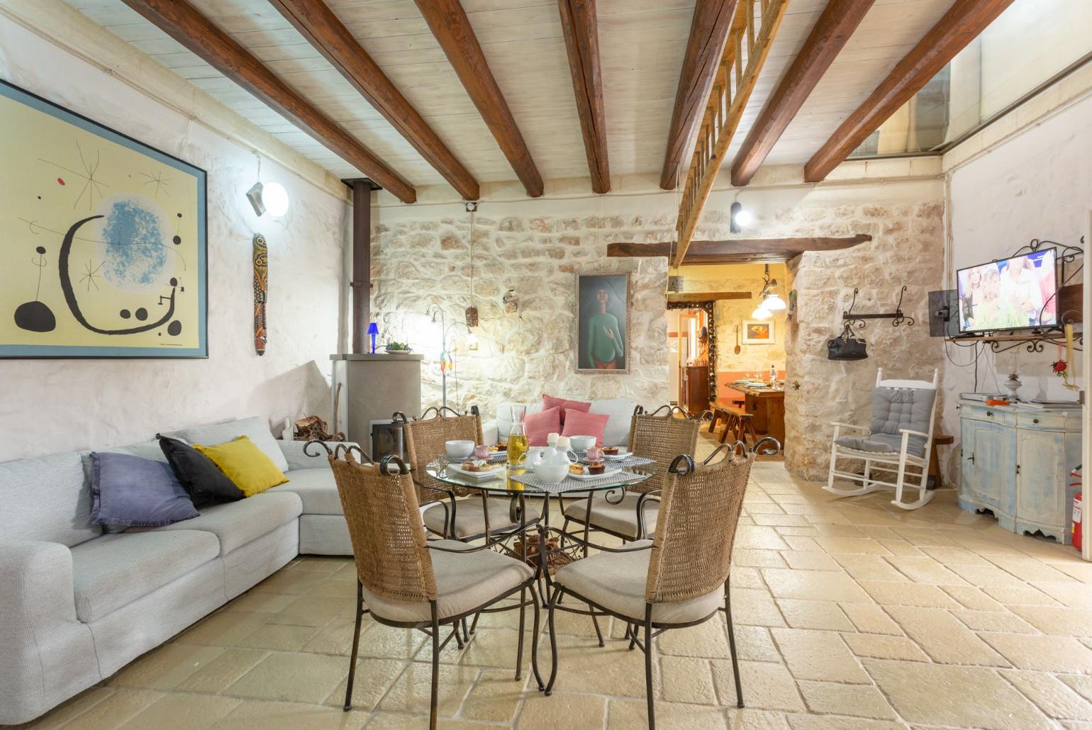 Living room with sofas, dining area, ornamental fireplace, WiFi internet, satellite TV, and terrace access
