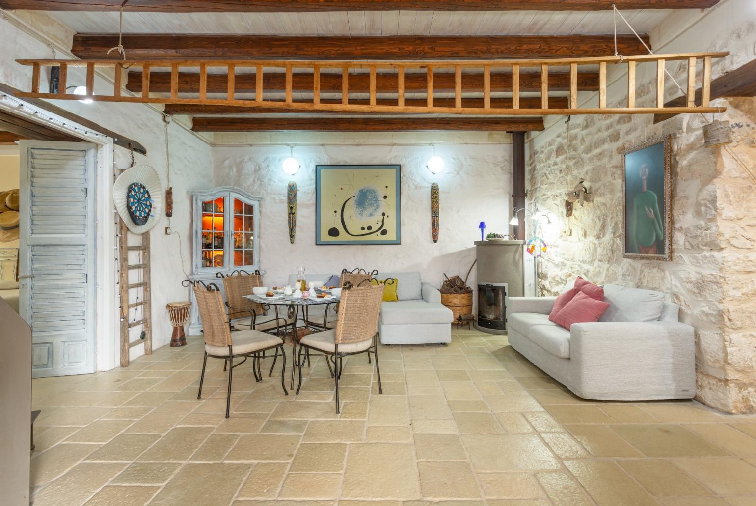 Living room with sofas, dining area, ornamental fireplace, WiFi internet, satellite TV, and terrace access