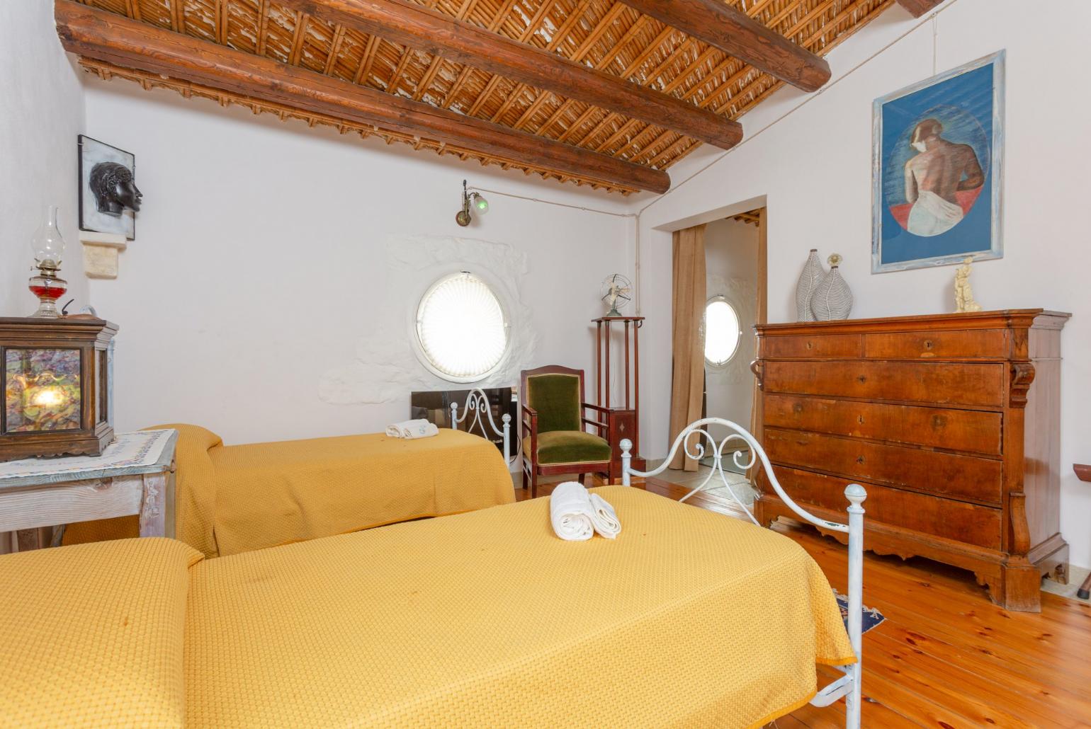 Twin bedroom with en suite bathroom and balcony access