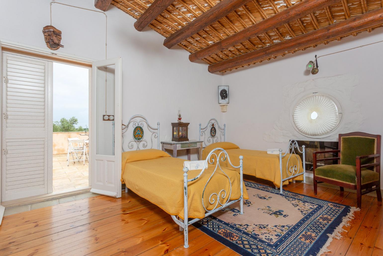 Twin bedroom with en suite bathroom and balcony access