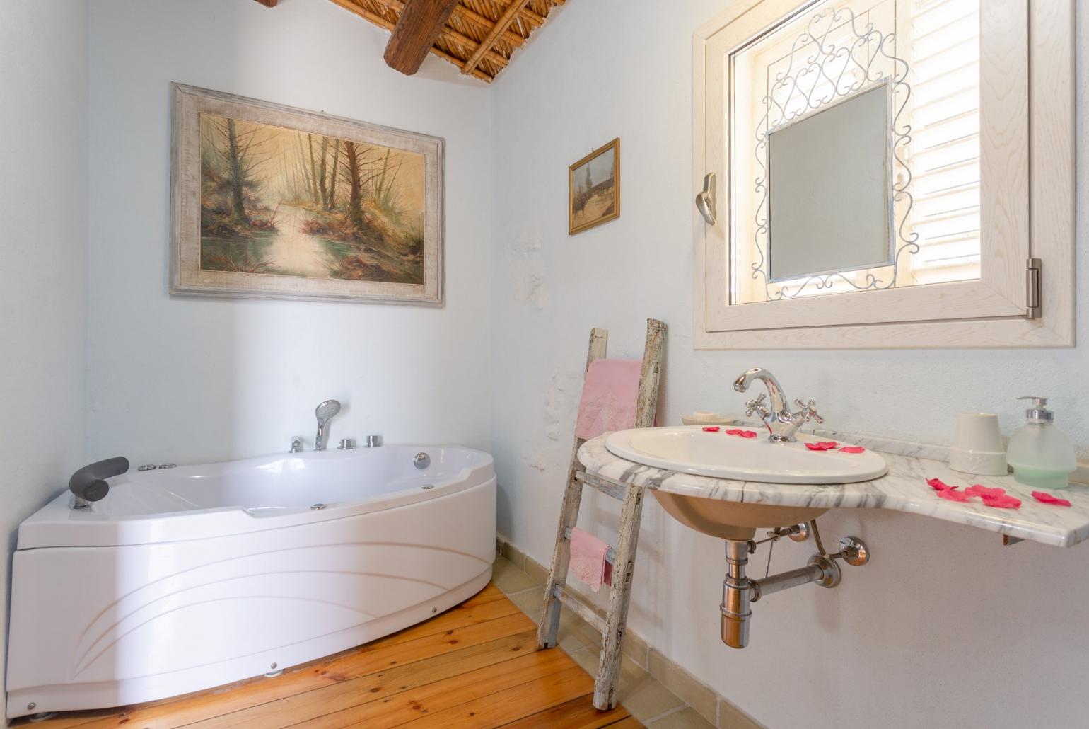 En suite bathroom with spa bath and shower