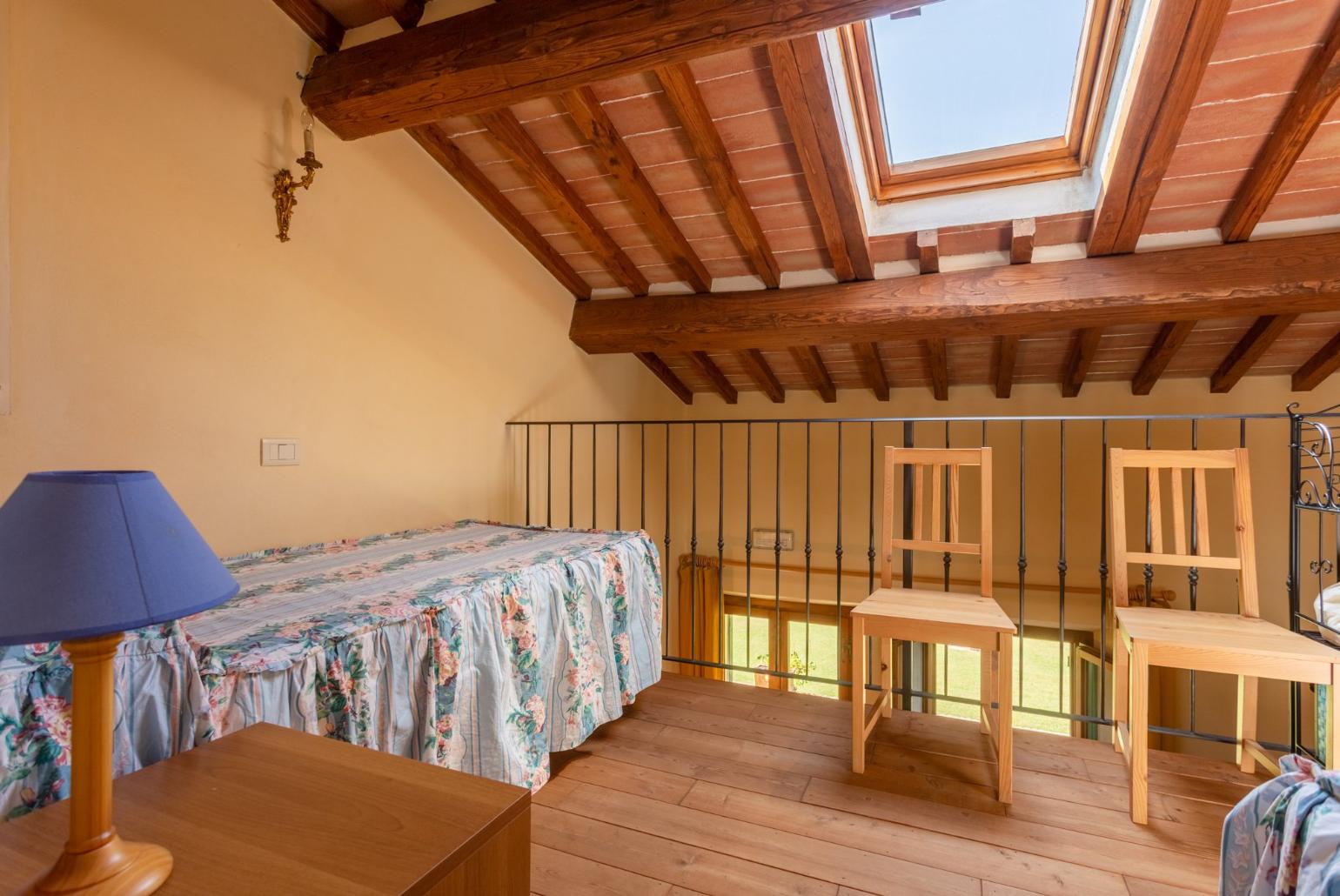 Twin bedroom on mezzanine of living room 