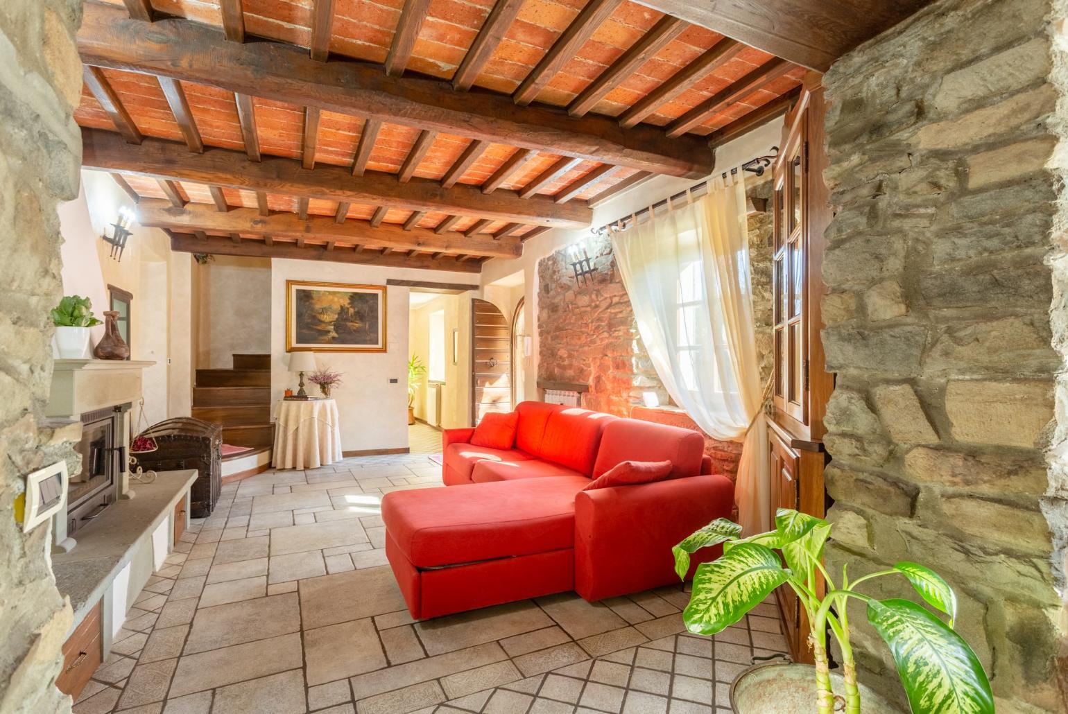 Open-plan living room with sofas, dining area, kitchen, ornamental fireplace, WiFi internet, satellite TV, and garden access