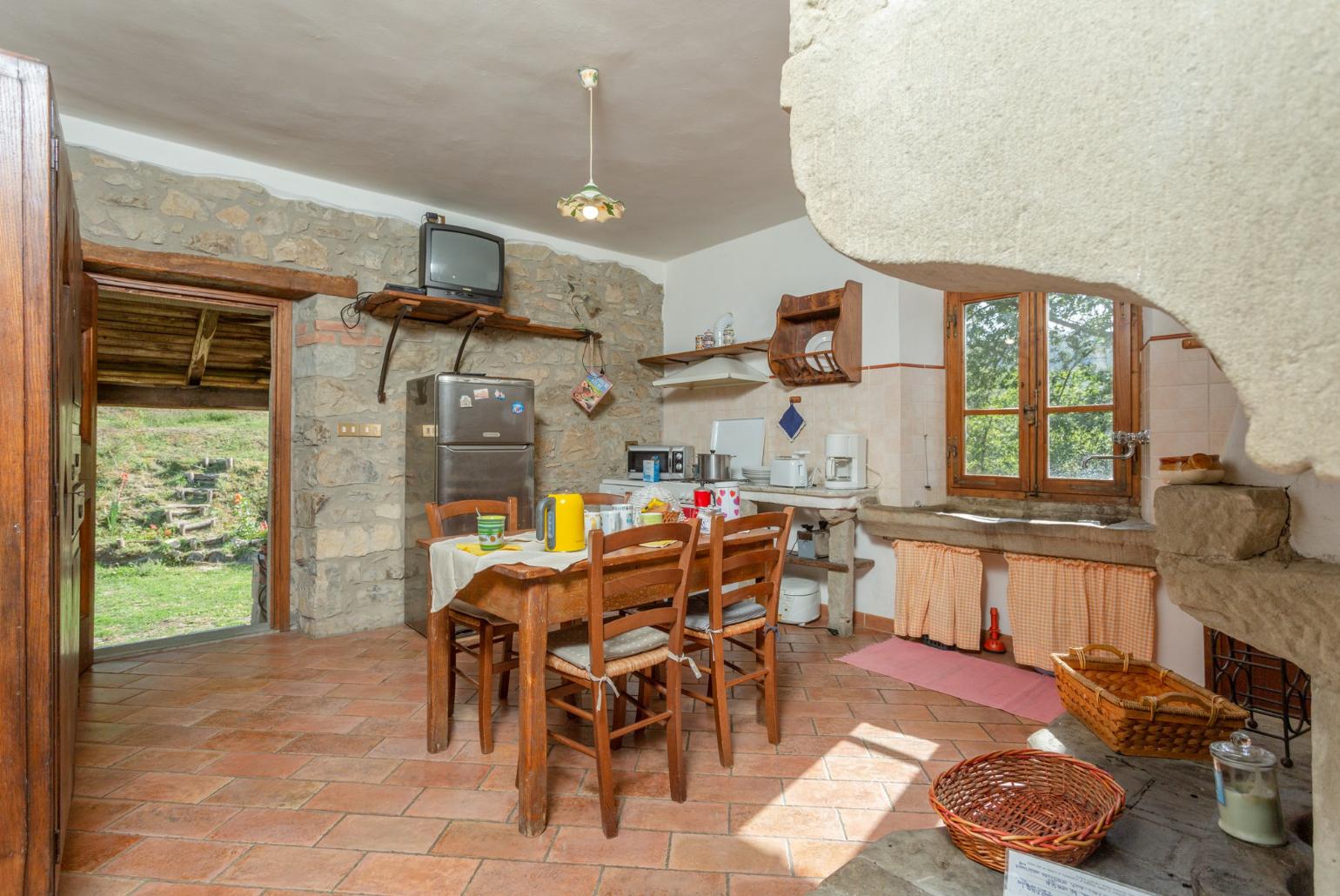 Equipped kitchen on first floor with dining area and ornamental fireplace