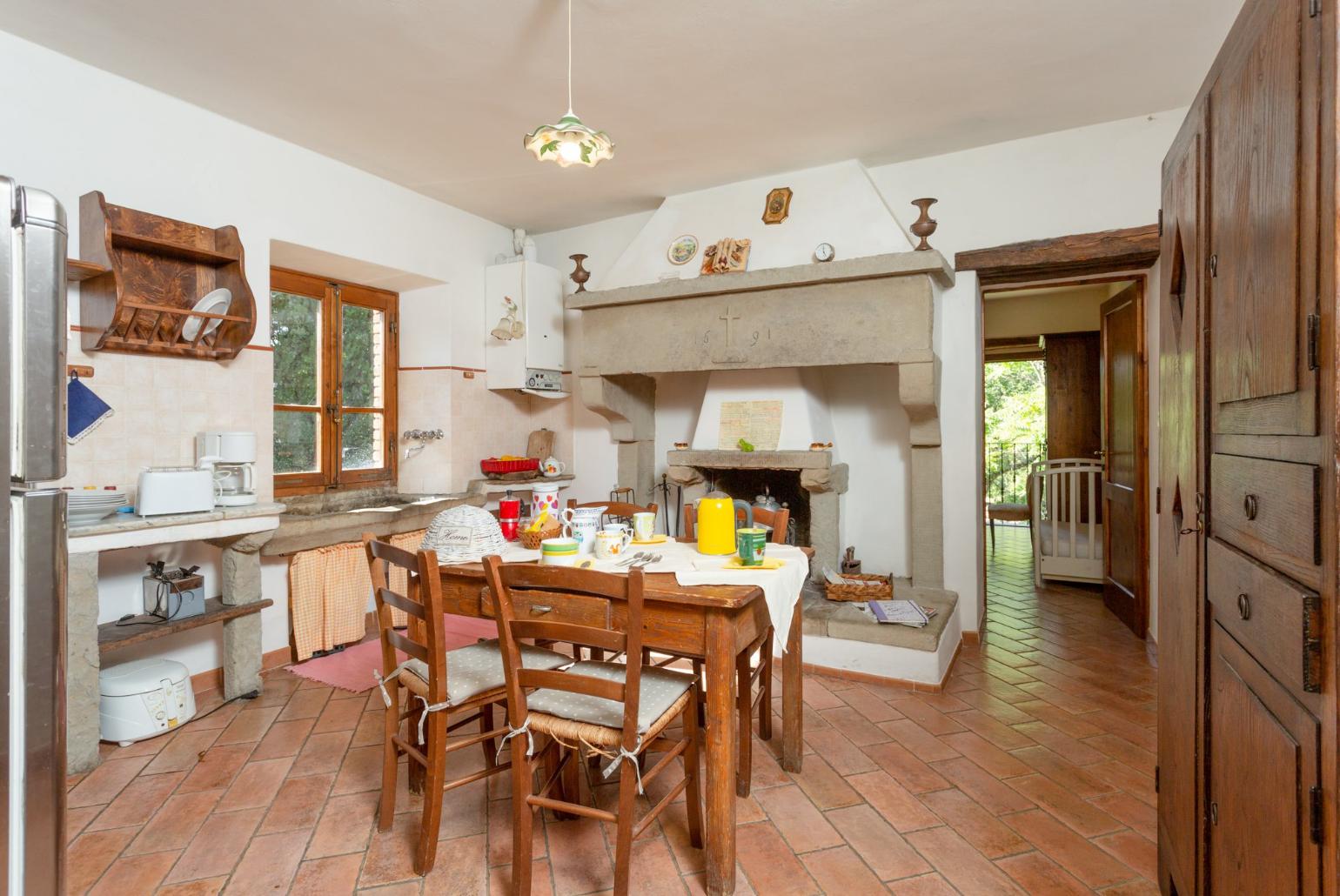 Equipped kitchen on first floor with dining area and ornamental fireplace