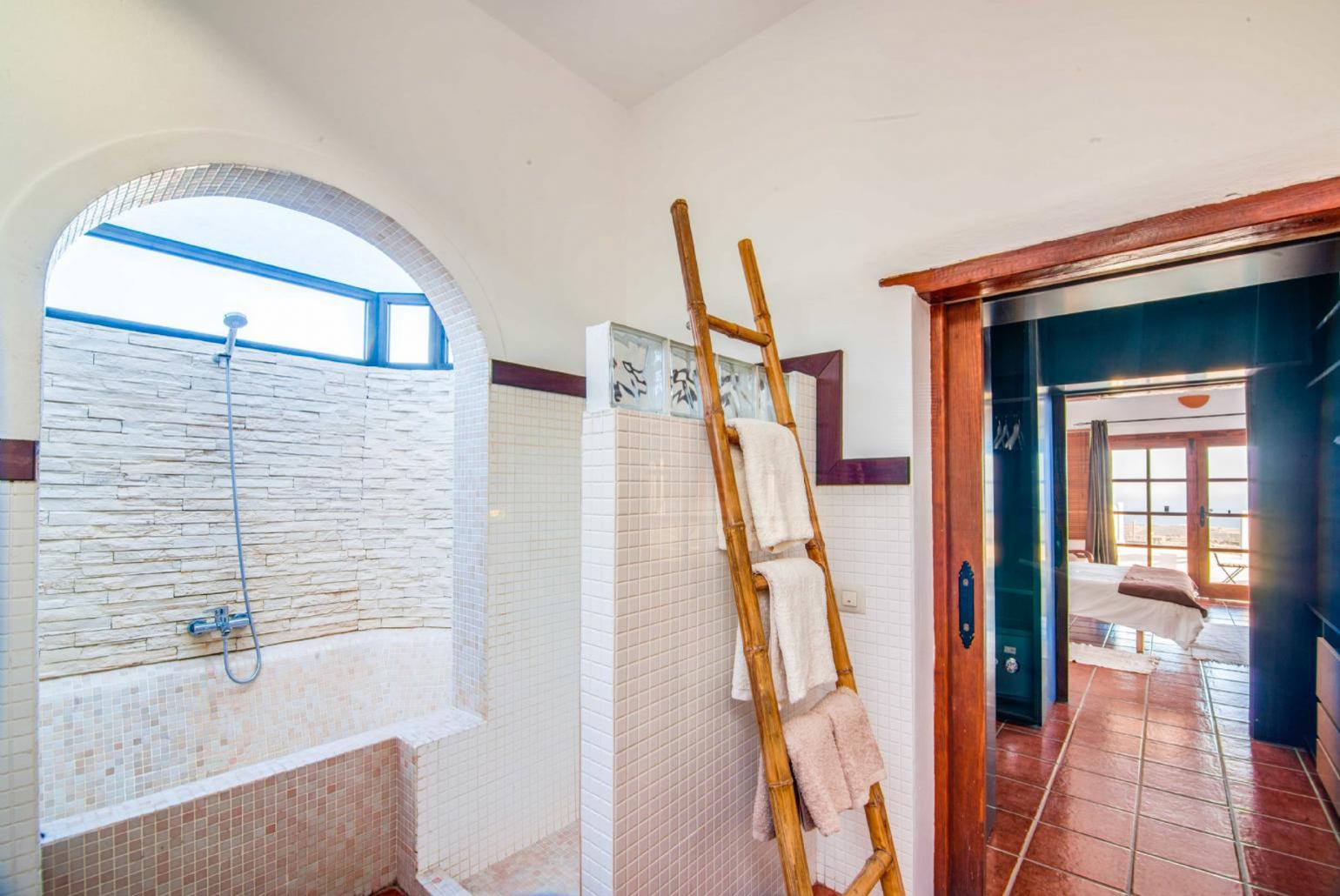 En suite bathroom with bath and shower